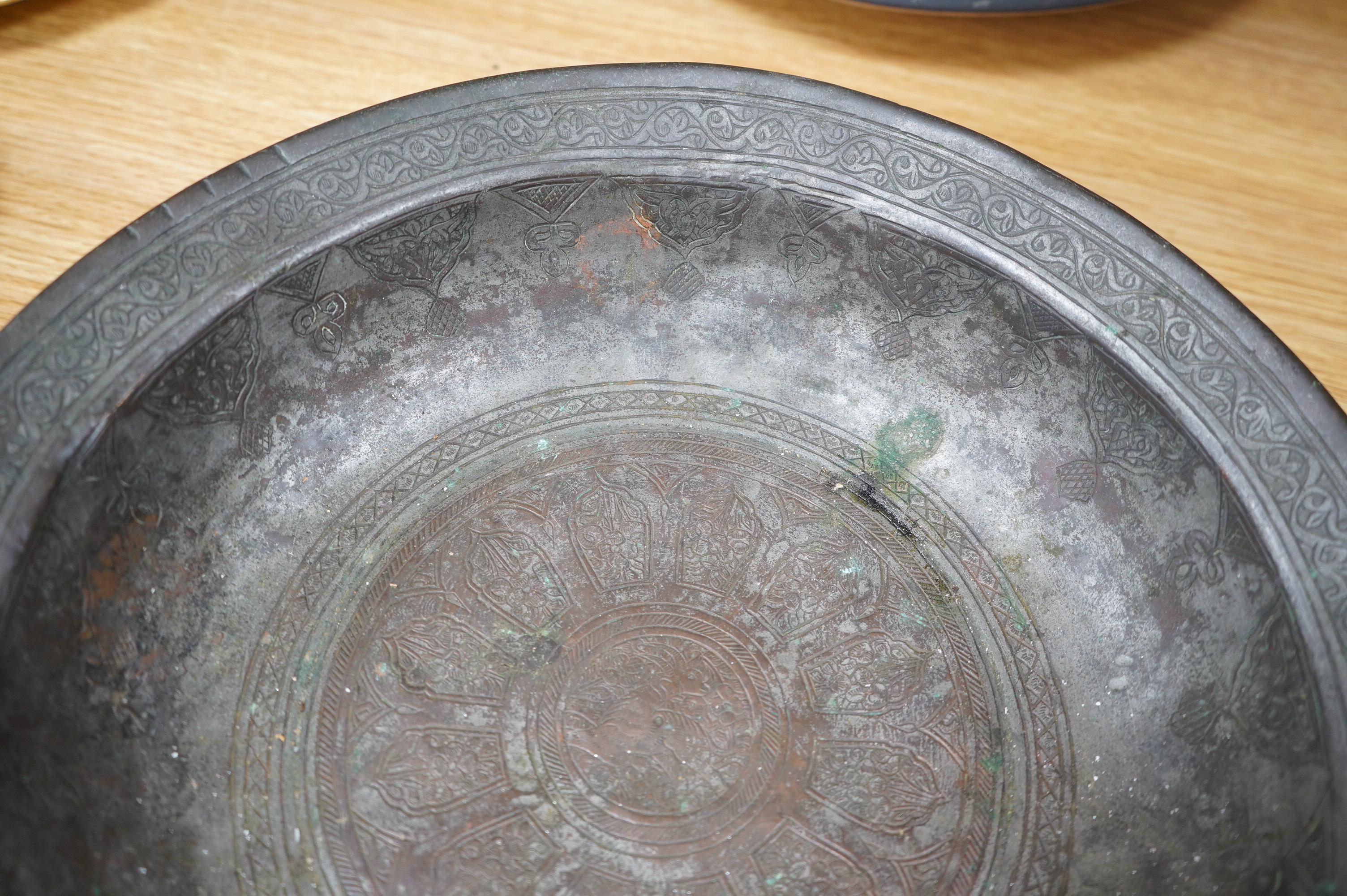 A Safavid tinned copper bowl engraved with a goat and flowers, 32cm diameter. Condition - fair